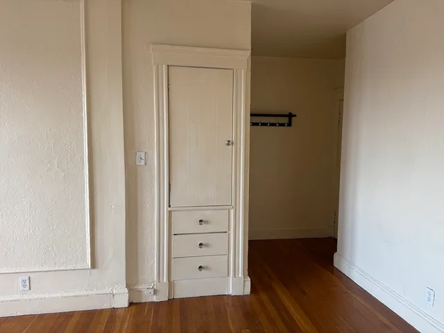 an empty room with wooden floor