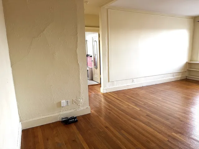 an empty room with wooden floor