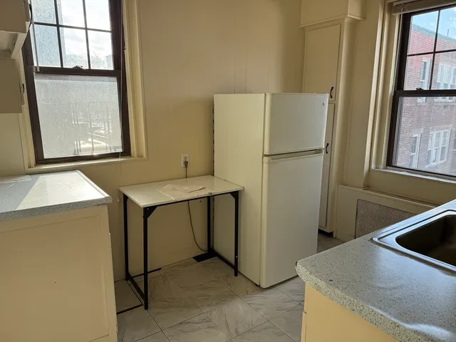a kitchen with a refrigerator and a sink