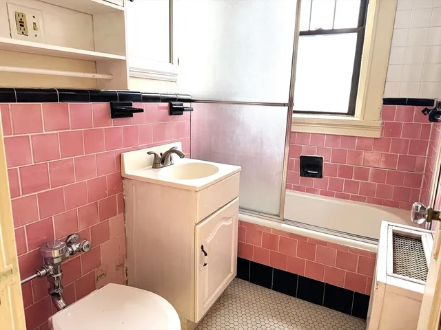 a bathroom with a sink toilet and mirror