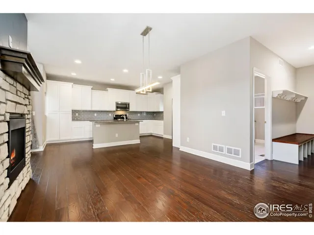 a view of kitchen with refrigerator microwave and wooden floor