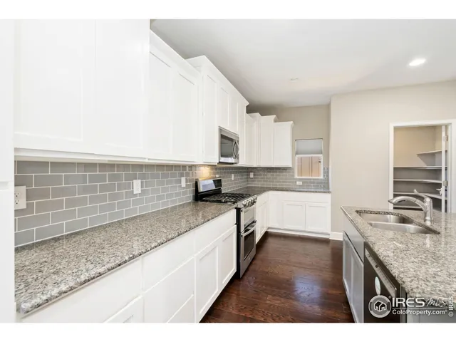 a large kitchen with kitchen island sink stainless steel appliances and a counter top space