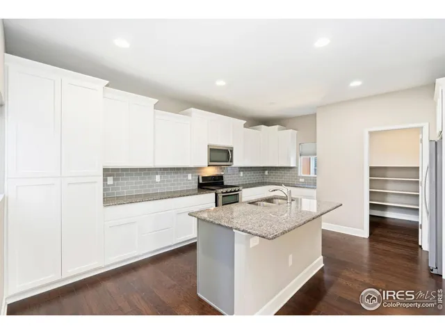 a kitchen with a sink microwave and cabinets