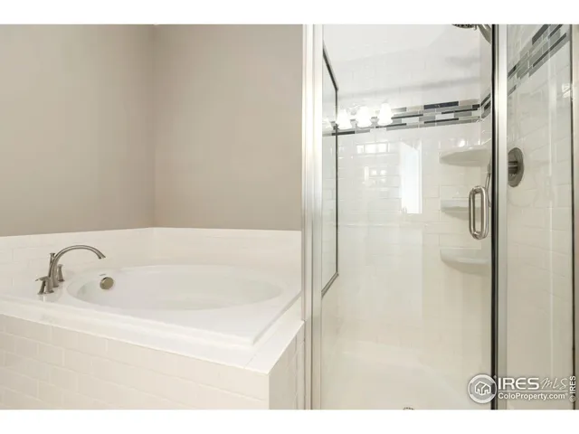 a bathroom with a tub and shower