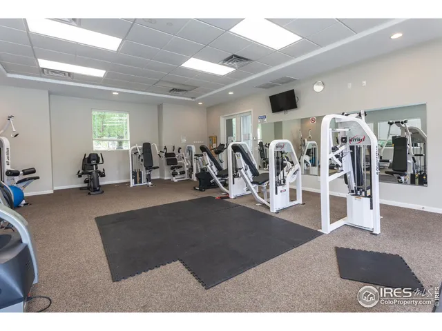 a front view of a house with a yard and potted plants