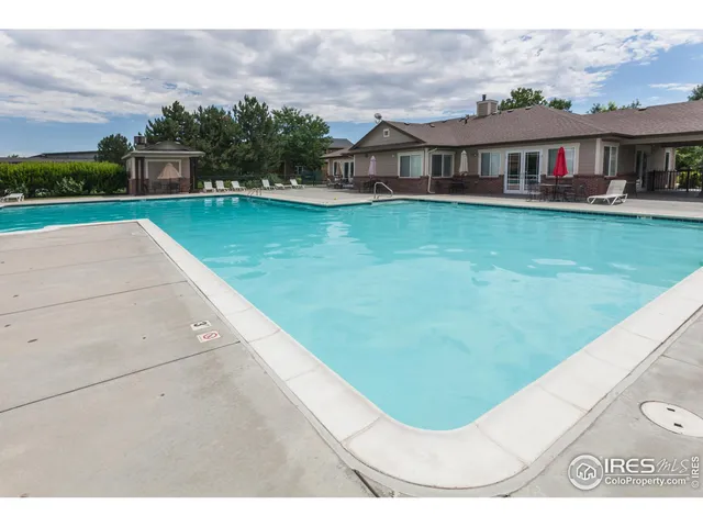 an aerial view of a house with a swimming pool and outdoor seating