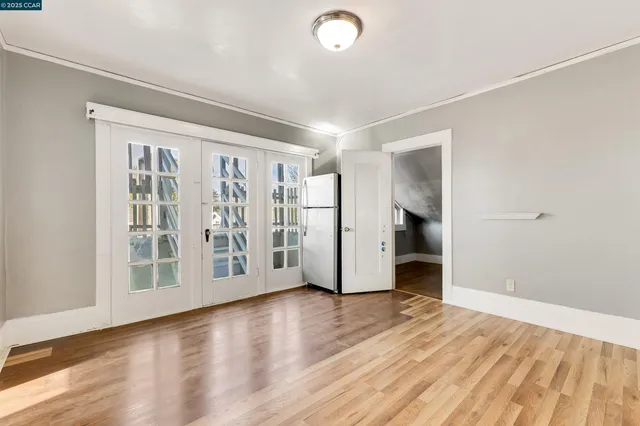 a view of an empty room with wooden floor