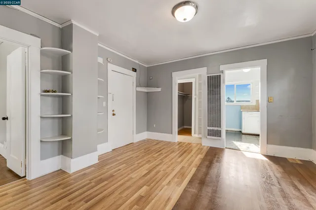a view of a room with wooden floor and windows