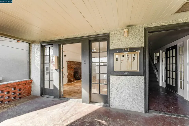 a hallway with sliding door and wooden floor