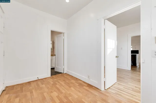 a view of a room with wooden floor