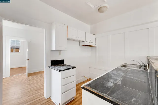 a kitchen with granite countertop a stove and a sink