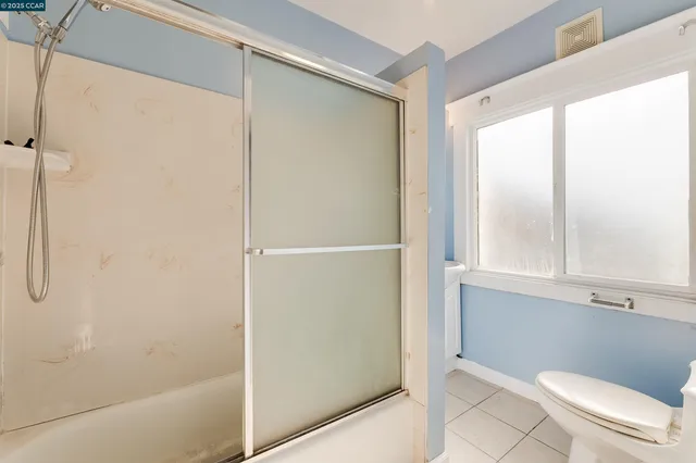 a bathroom with a shower and a toilet