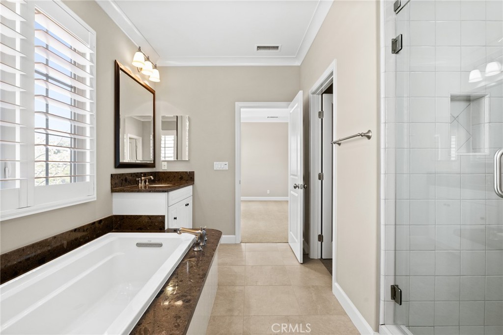 98 Cipresso Irvine, CA 92618 - Photo 22 of 59 a bathroom with a tub a sink and a large mirror