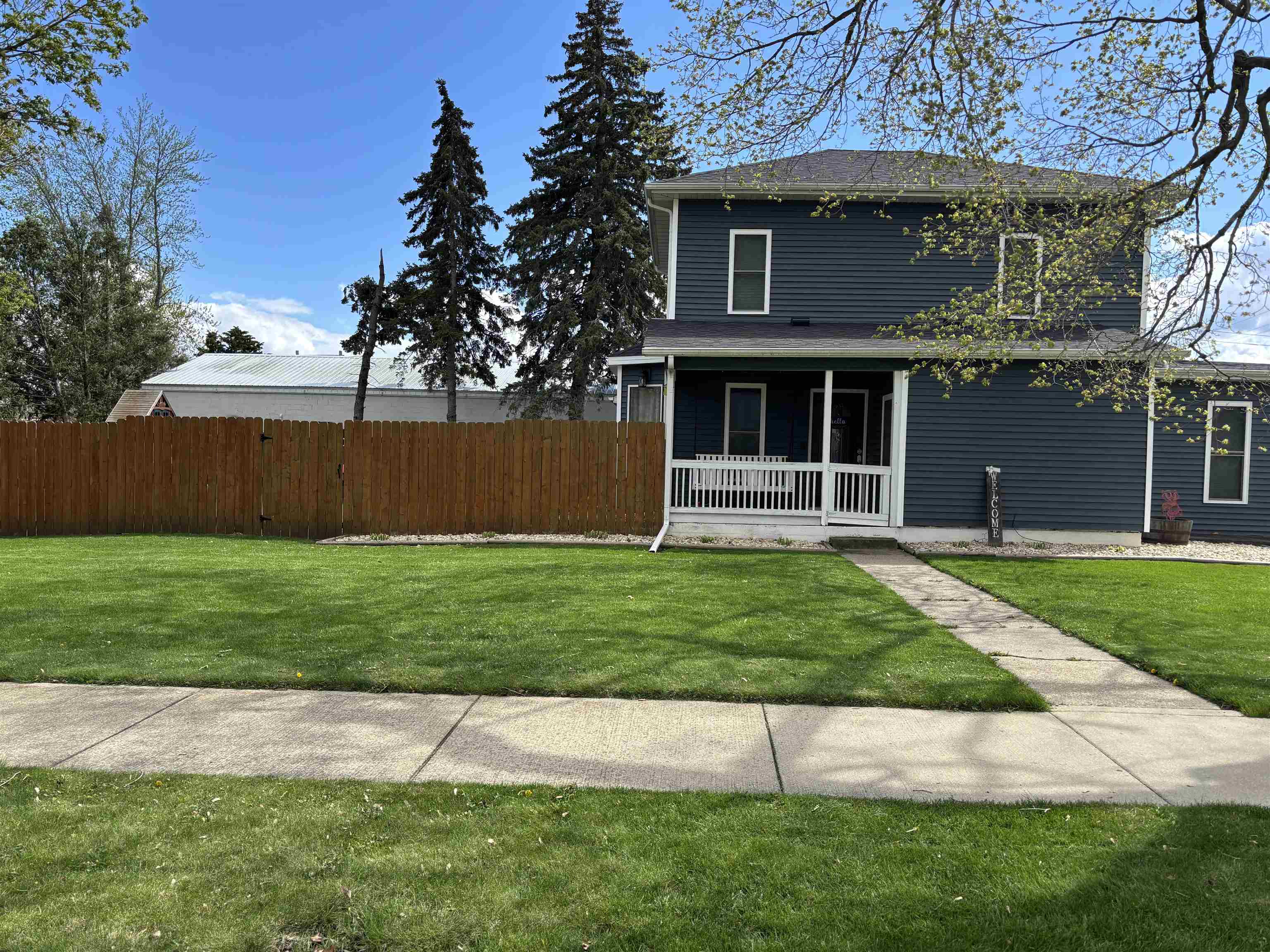 732 West 2nd Street Byron, IL 61010 - Photo 2 of 22 a front view of a house with a garden and yard