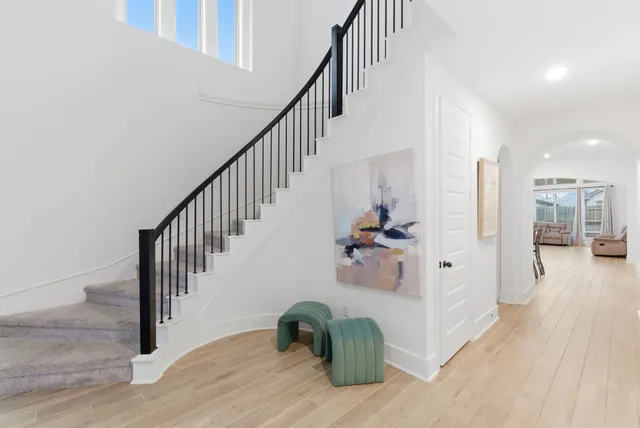 a view of entryway and hall with wooden floor
