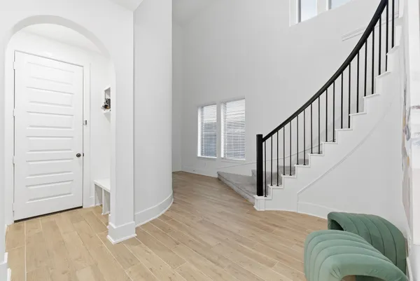 a view of entryway and hall with wooden floor