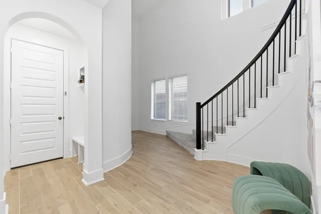 a view of entryway and hall with wooden floor