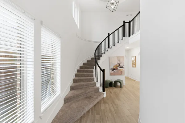 a view of entryway and hall with wooden floor
