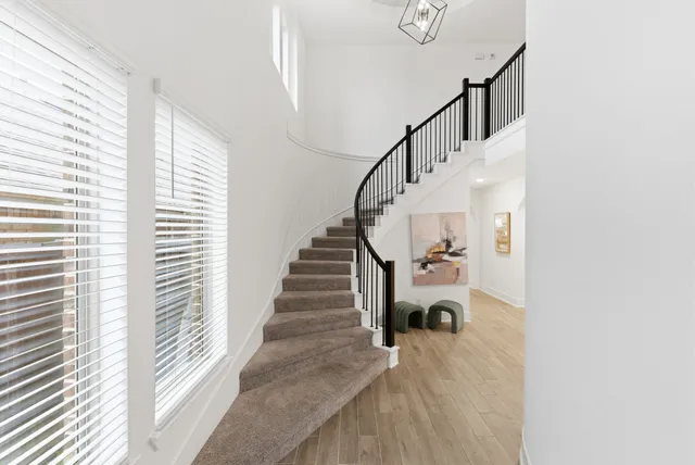 a view of entryway and hall with wooden floor