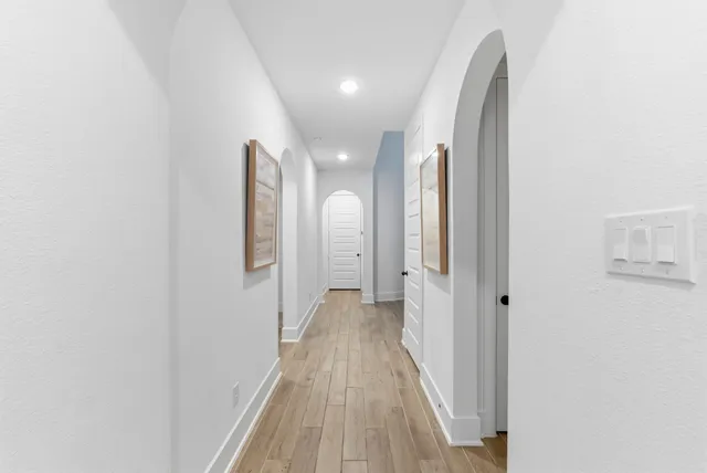 a view of a hallway with wooden floor