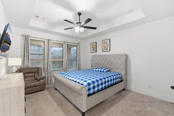 a bedroom with a bed couch and window