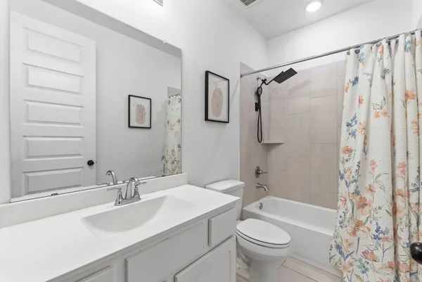 a bathroom with a sink toilet tub and shower