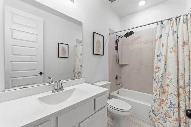 a bathroom with a sink toilet tub and shower