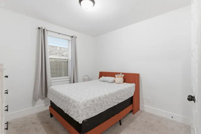 a bedroom with a bed and window