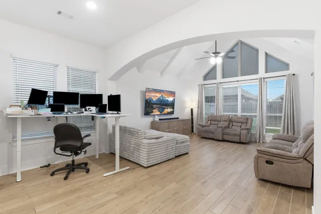 a living room with furniture and a flat screen tv