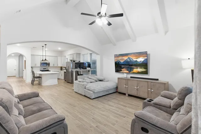a living room with furniture and a flat screen tv
