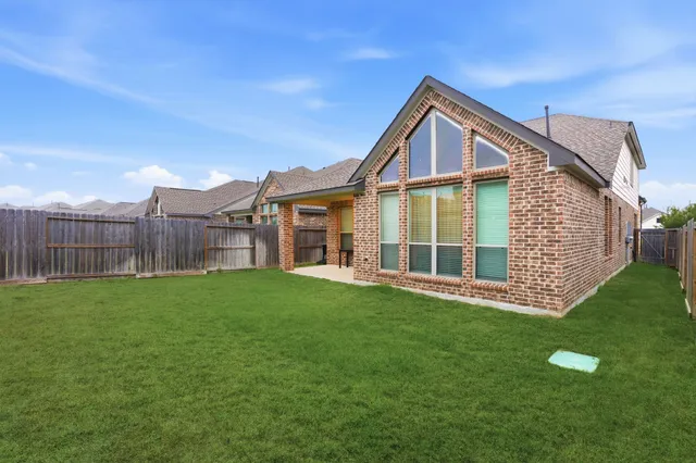 a view of a house with a yard and deck