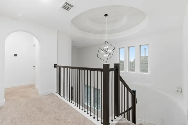 a view of a hallway with a chandelier