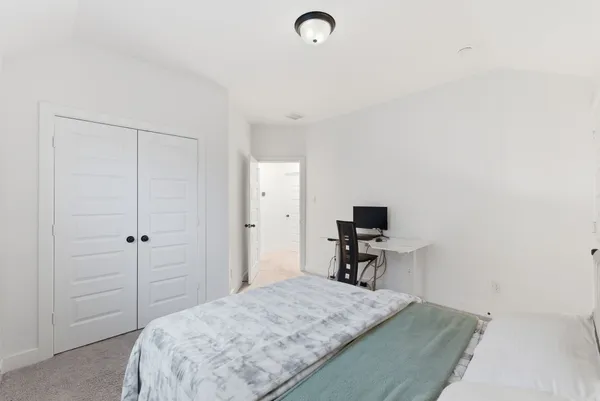 a bedroom with a bed and a table in it