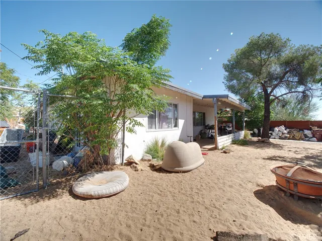 a swimming pool with outdoor seating and yard