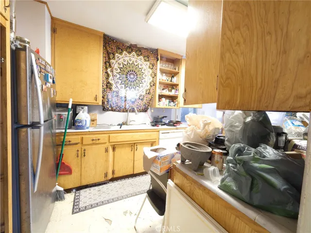 a kitchen with sink refrigerator and window