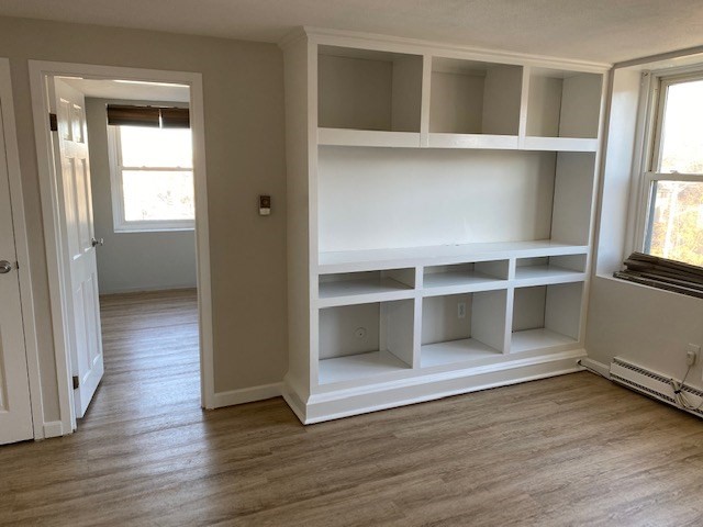 340 Main Street, Unit 501 Melrose, MA 02176 - Photo 2 of 11 an empty room with wooden floor and windows