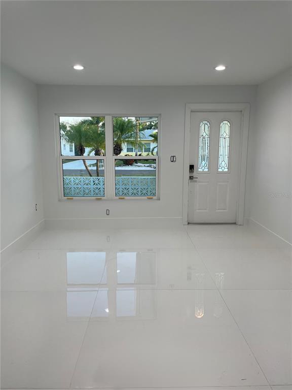 16102 1st Street East Redington Beach, FL 33708 - Photo 11 of 39 wooden floor in an empty room with a window