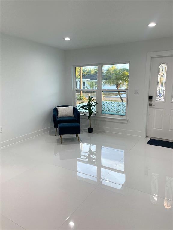 16102 1st Street East Redington Beach, FL 33708 - Photo 12 of 39 a living room with furniture and large windows