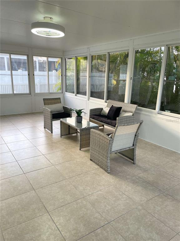 16102 1st Street East Redington Beach, FL 33708 - Photo 13 of 39 a living room with furniture and large windows
