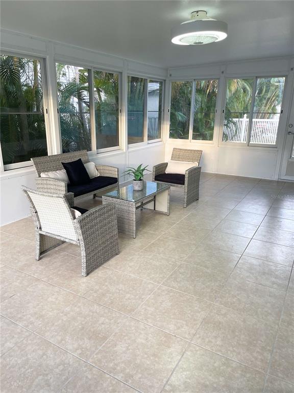 16102 1st Street East Redington Beach, FL 33708 - Photo 14 of 39 a living room with furniture and large windows