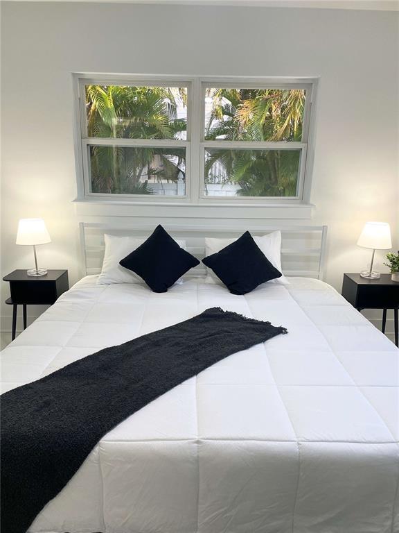 16102 1st Street East Redington Beach, FL 33708 - Photo 17 of 39 a bedroom with a large bed and a large window