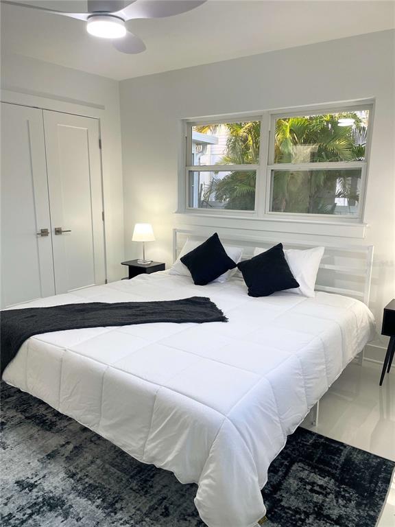 16102 1st Street East Redington Beach, FL 33708 - Photo 18 of 39 a bedroom with a large bed and a large window