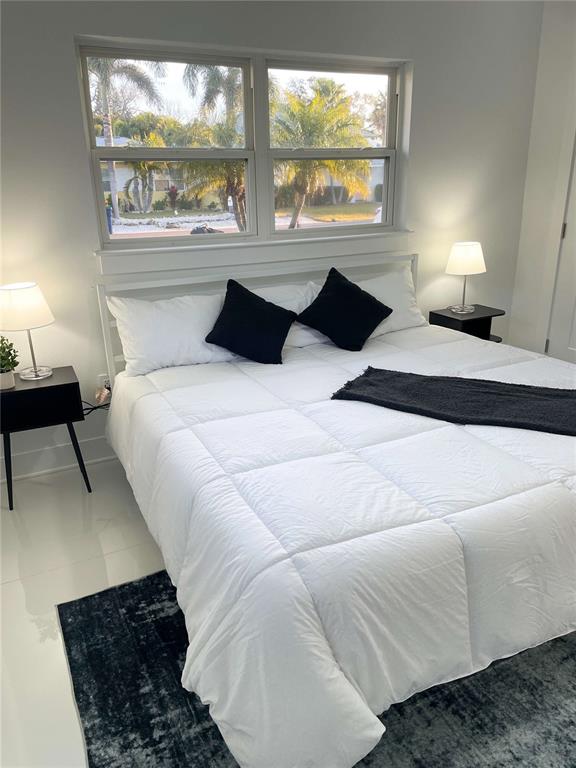 16102 1st Street East Redington Beach, FL 33708 - Photo 20 of 39 a bedroom with a bed and a large window