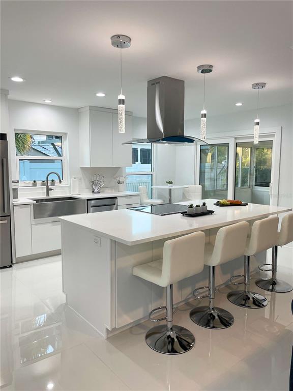 16102 1st Street East Redington Beach, FL 33708 - Photo 2 of 39 a kitchen with a dining table chairs sink and cabinets