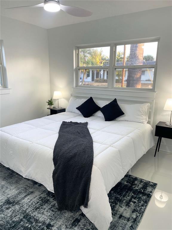 16102 1st Street East Redington Beach, FL 33708 - Photo 21 of 39 a bedroom with a bed and a large window