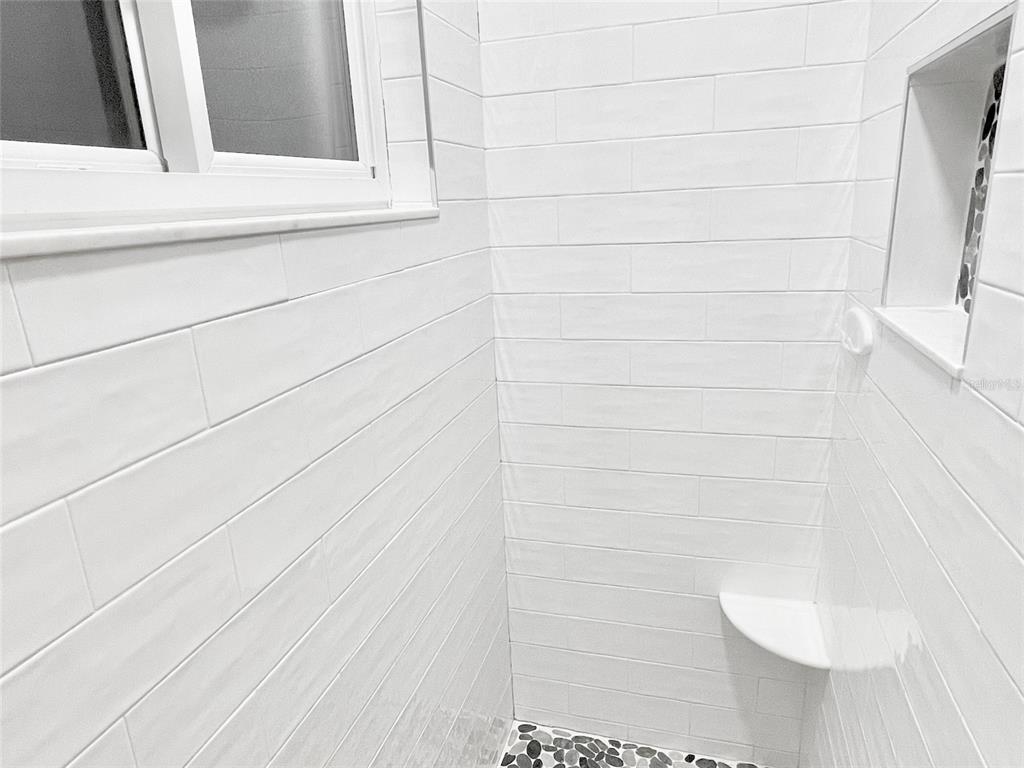 16102 1st Street East Redington Beach, FL 33708 - Photo 26 of 39 a bathroom with a white toilet and a shower