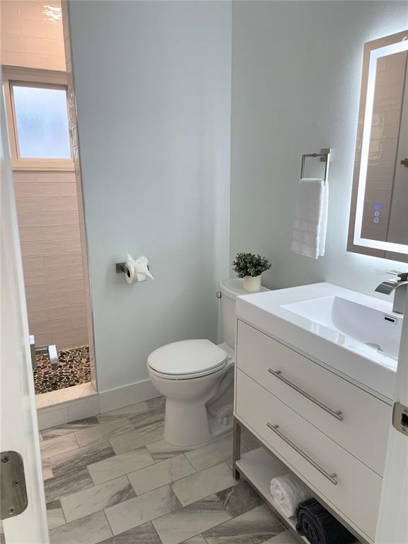 16102 1st Street East Redington Beach, FL 33708 - Photo 27 of 39 a bathroom with a sink a toilet and shower