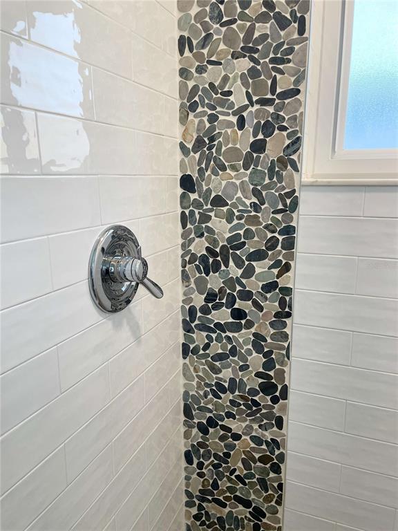 16102 1st Street East Redington Beach, FL 33708 - Photo 29 of 39 a bathroom with a shower and a window