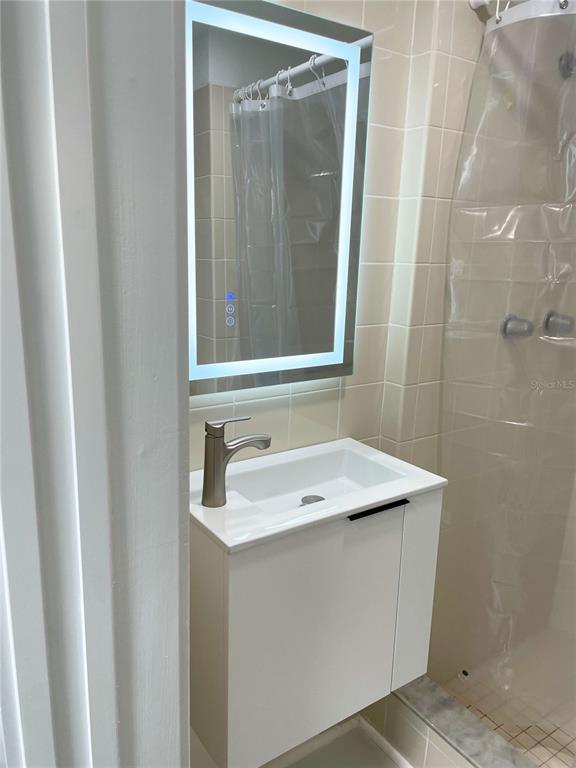 16102 1st Street East Redington Beach, FL 33708 - Photo 30 of 39 a bathroom with a sink and a mirror