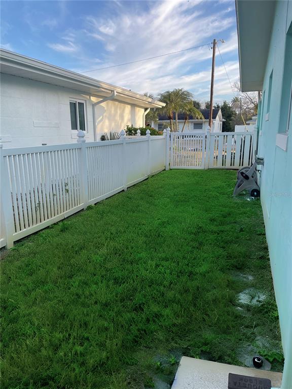 16102 1st Street East Redington Beach, FL 33708 - Photo 37 of 39 a view of a backyard with plants and wooden fence